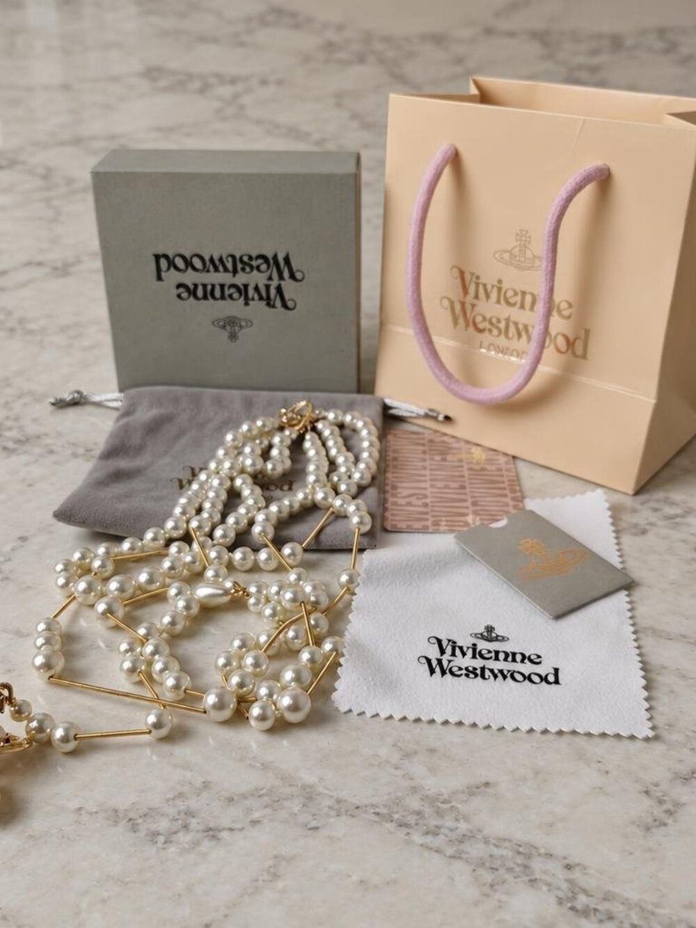 Vivienne Westwood Irregular Three Row Pearl Bas Relief Choker in gold